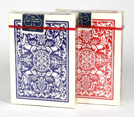 Two decks of playing cards, one blue and one red, with intricate designs on a white background.
