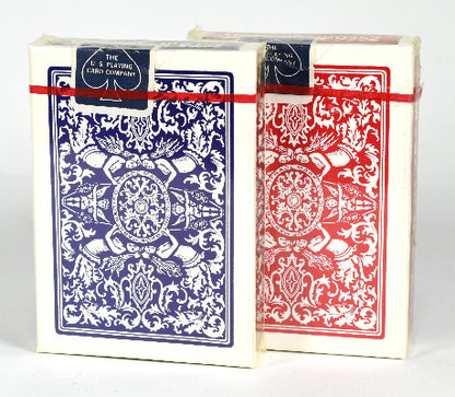 Two decks of playing cards, one blue and one red, with intricate designs on a white background.