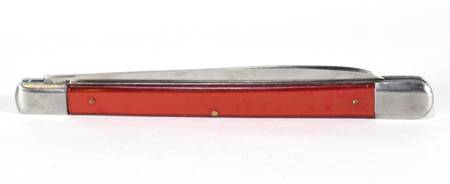 Red pocket knife with silver blade on a white background