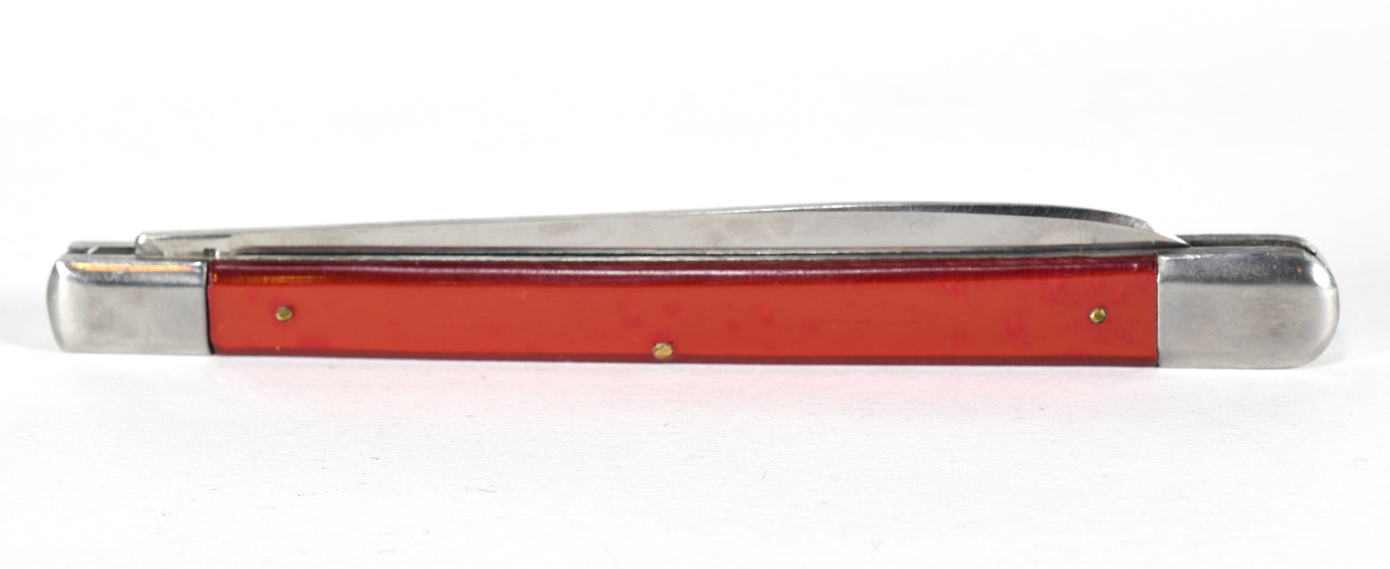 Red pocket knife with silver blade on a white background