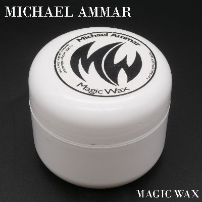 White container of Michael Ammar Magic Wax on a black background
