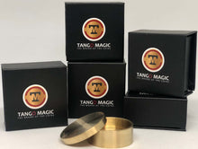 Set of black boxes with Tango Magic logo and two brass containers on a white background