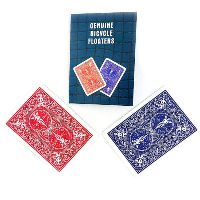 Two decks of Bicycle Floaters playing cards, one red and one blue, with a blue deck cover displaying text.