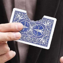 Hand holding a blue playing card with intricate design against a dark background