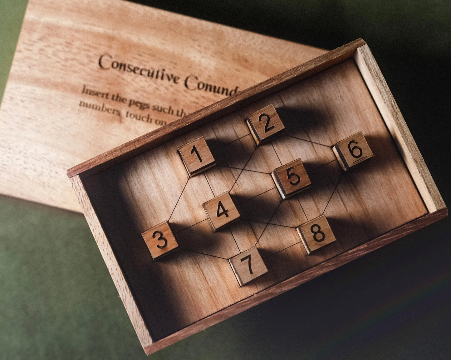 Wooden puzzle with numbered blocks inside a wooden box