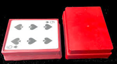 Red playing cards with a clear plastic cover on a black background