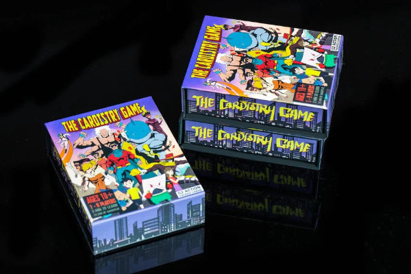 Three editions of 'The Candystrip Game' on a dark reflective surface