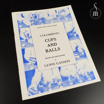 Booklet titled 'Colombini's Cups and Balls' by Lewis Ganson on a dark background