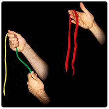 Three hands holding colorful strings against a black background