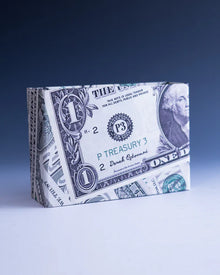 Cardboard box designed to resemble a one-dollar bill on a blue background