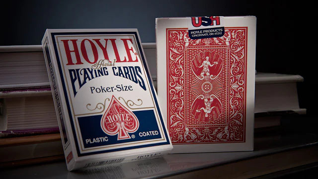 Two Hoyle playing card boxes on a dark surface