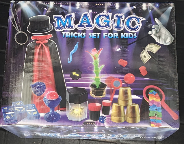 Packaging of a magic tricks set for kids with various props and a magician silhouette.