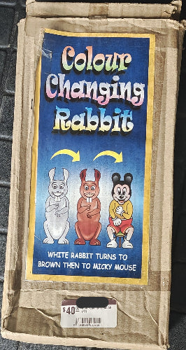 Vintage packaging of a 'Colour Changing Rabbit' toy with cartoon illustrations on a blue background.