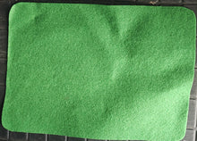 Green felt sheet on a black surface