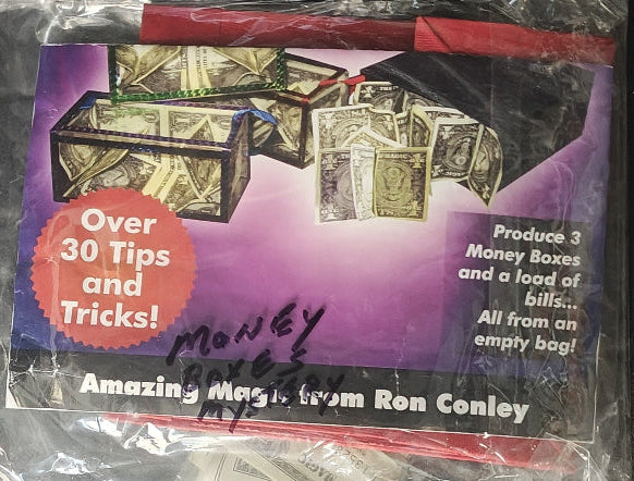 Packaged magic trick set with money-themed packaging and text about tips and tricks.