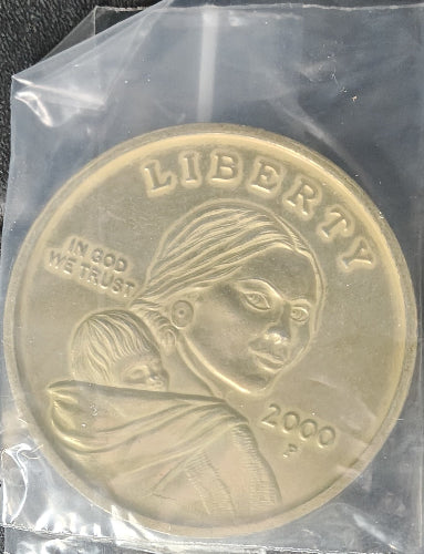Gold coin with a person design, encased in clear plastic