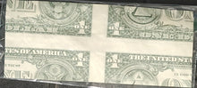 Four sheets of U.S. dollar bills stacked together