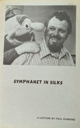 Black and white photo of a man with a puppet, titled 'Symphanet in Silks' by Paul Diamond.