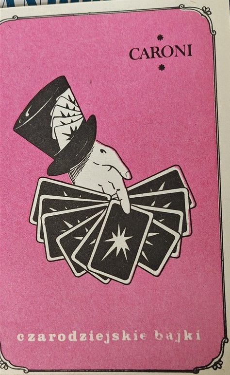 Card with a hand holding playing cards against a pink background, featuring the brand 'Caroni'.