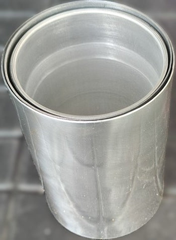 Metallic cylindrical object with a reflective surface on a blurred background
