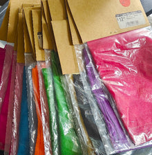 Colorful paper sheets in various packages on a flat surface