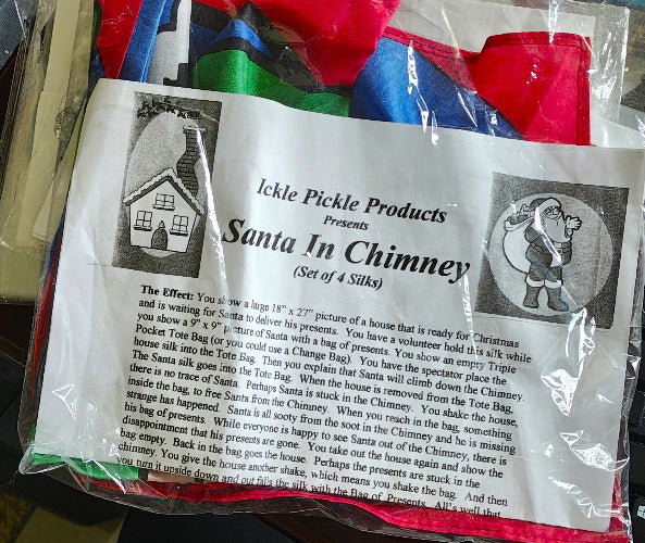 Set of colorful silks with a Santa in Chimney scenario and Ickle Pickle Products packaging.
