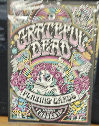 Colorful 'Cartel Ink' playing cards packaging with skull and floral design.