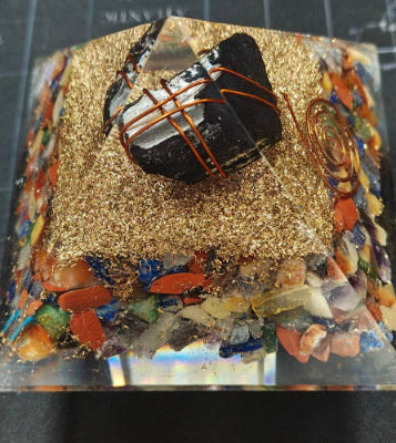 Small model of a piano on a decorative surface with a ruler in the background