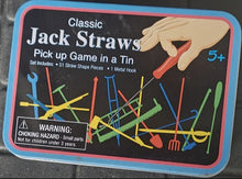 Box of Jack Straws game on a black car mat