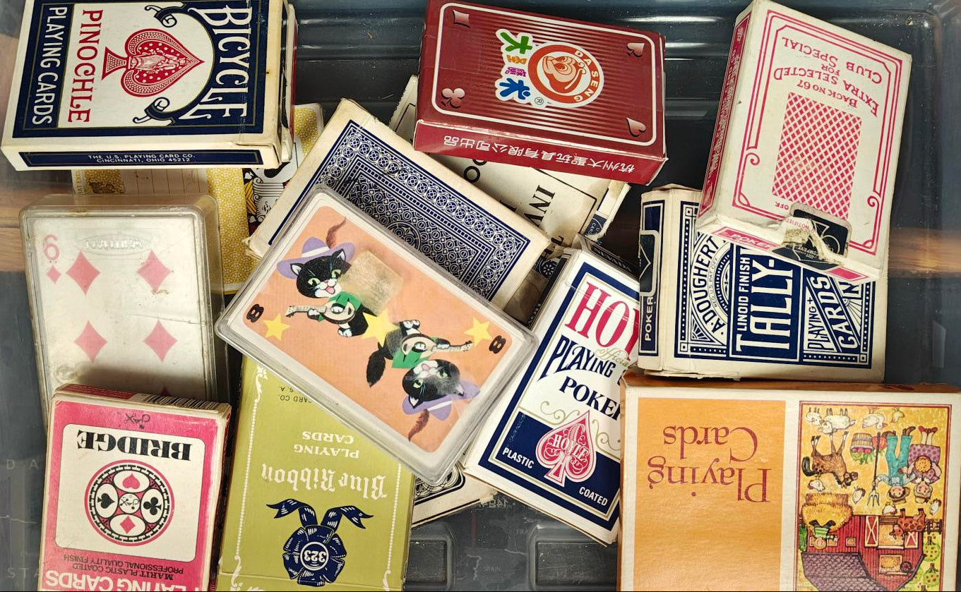 Collection of various playing cards with different designs and brands.