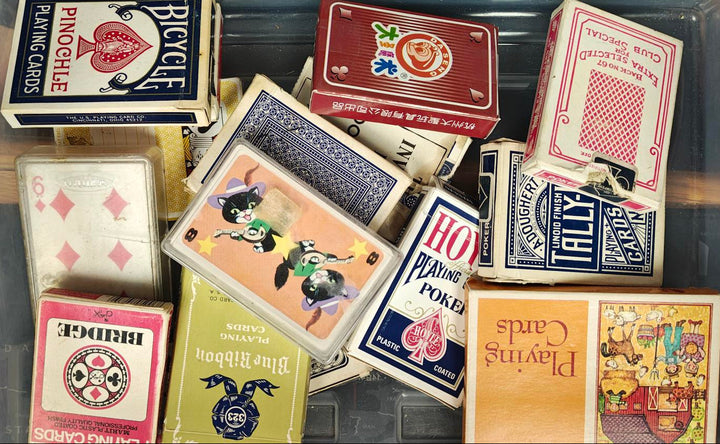 Collection of various playing cards with different designs and brands.