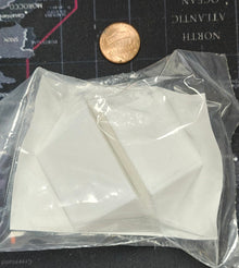 Clear plastic bag with white geometric shapes on a map background