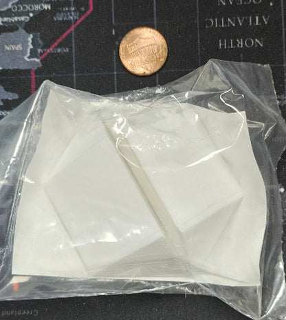 Clear plastic bag with white geometric shapes on a map background