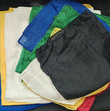 Stack of colorful folded cloths on a black surface