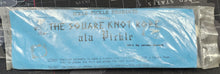 Packaged product with blue label and silver packaging on a black background