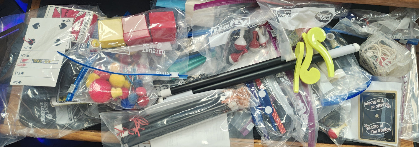 Assorted toys and items on a table with plastic bags.