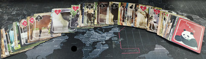 Collection of playing cards on a world map