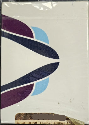 Product packaging with abstract design and 'Iowa Magic Shop' text on a white background