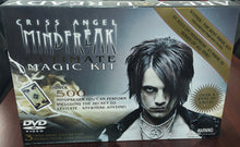 Criss Angel Mindfreak DVD and Magic Kit on a table with books in the background