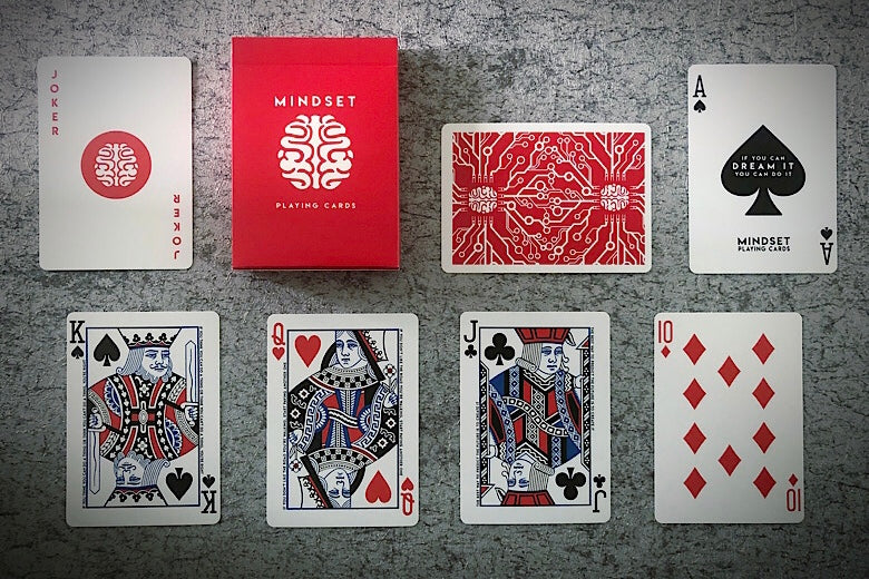 Collection of playing cards with Mindset branding on a textured surface