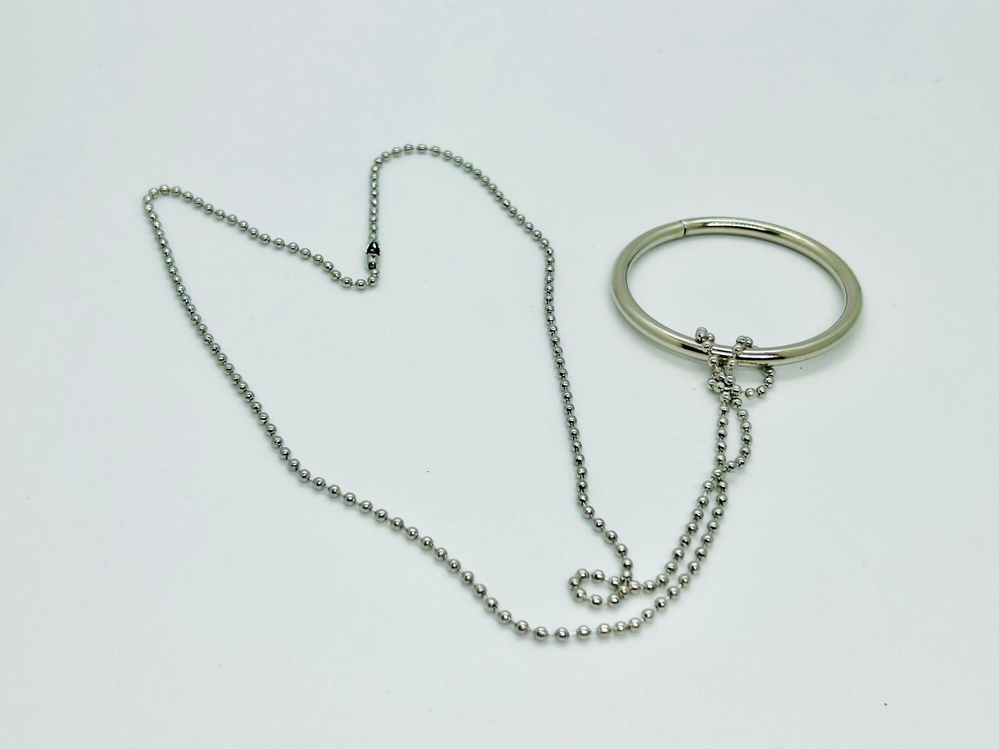 Silver necklace and bracelet on a white background