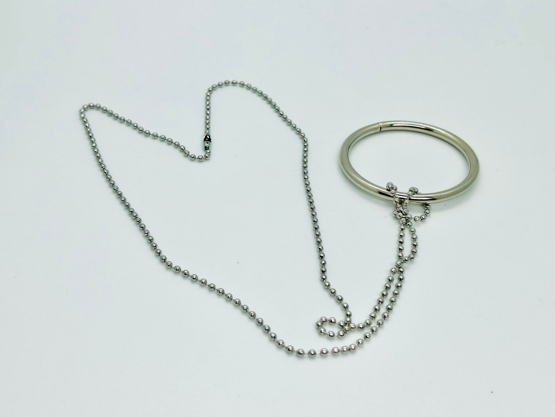 Silver necklace and bracelet on a white background