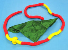 Colorful dog toy with green fabric center on a blue background