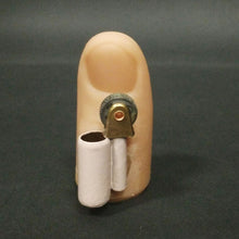 Small mechanical device with a cylindrical component and gear-like mechanism on a dark background