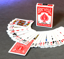 Bicycle playing cards with a deck fanned out on a gray surface