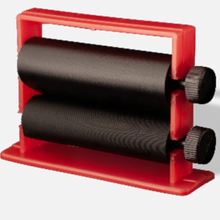 Red manual roller with black rollers on a white background