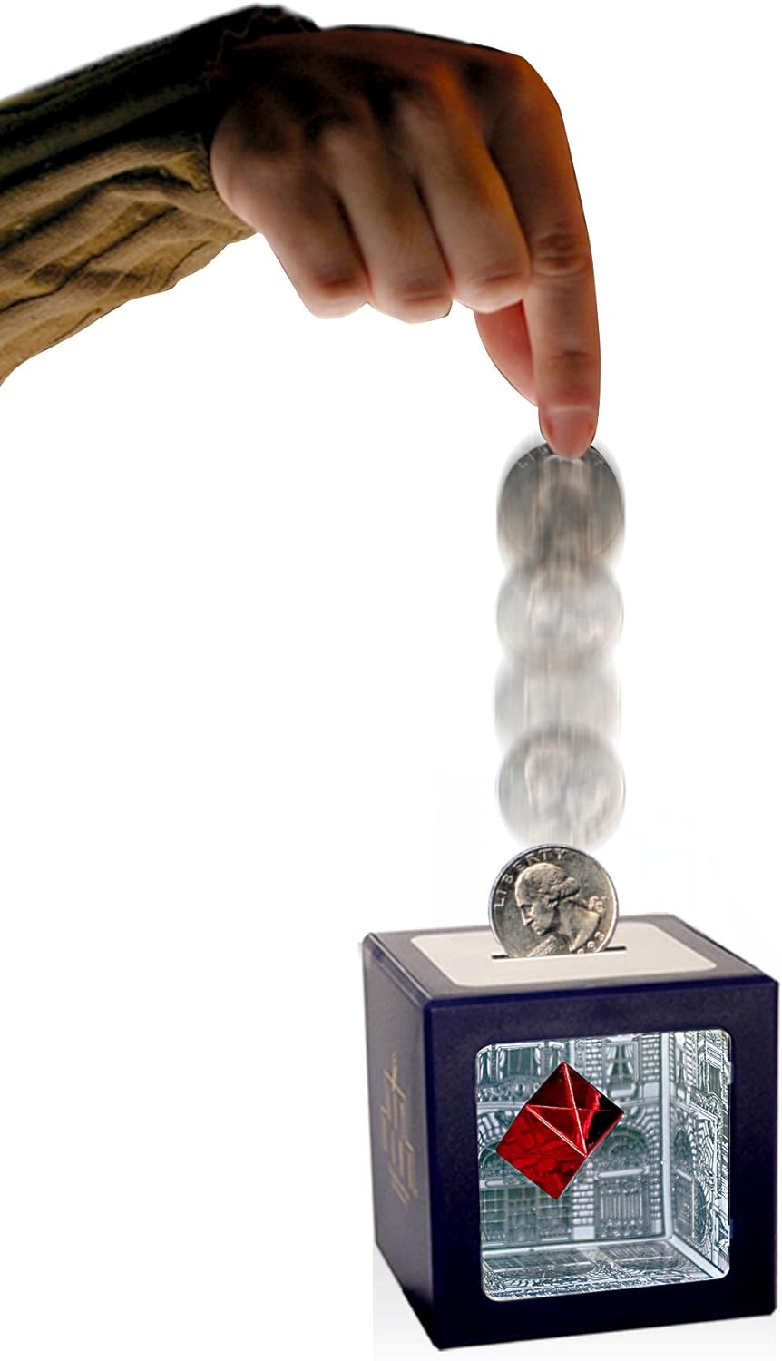 Hand holding a wooden stick with a marble on top of a decorative box featuring a red and blue design.