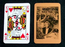 Playing card with King of Hearts and a Norm Nielsen Magic card on a black background