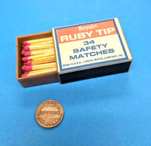 Box of Ruby Tip safety matches with matches partially extracted on a blue background