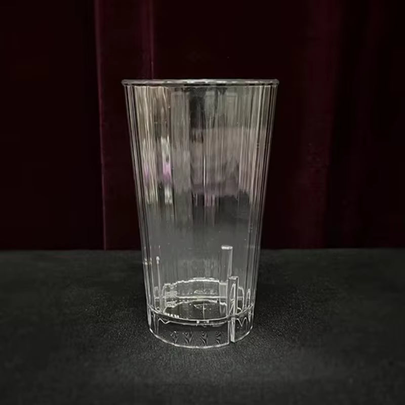 Clear glass tumbler with engraved design on a dark background